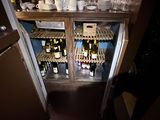 many bottles of wine sitting on the shelves in the kitchen