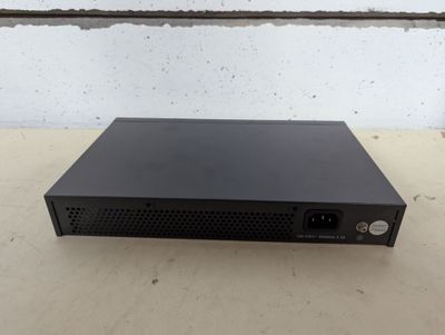 a black box sitting on top of a table next to a brick wall