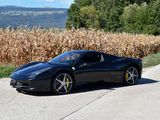 a black sports car that is parked on the side of the road