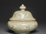 an image of a white vase with a lid sitting on a table