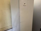 a refrigerator with a light on top of it in a room