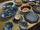 many plates and bowls sitting on a table together