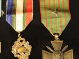 several medals are displayed in a display case on a black surface