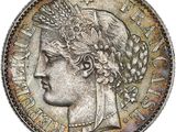 a silver coin with a woman ' s head on it