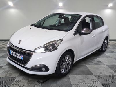 the small white car is parked in a large room