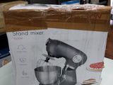 packaging of a stand mixer sitting on a table in a room