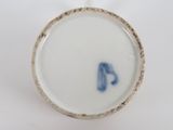 a close up view of a white cup with a blue handle