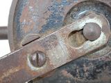 a close up of a rusted metal object on a white surface