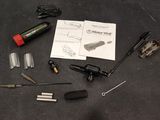 the contents of a bicycle repair kit laid out on a table