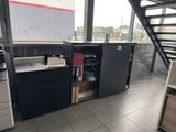 une photo d'un coin cuisine avec un évier, une cuisinière, des placards et un escalier