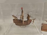 a small model of a ship in a glass case