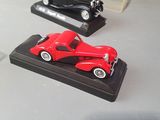 three toy cars on display on a table