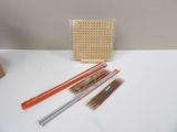 several different types of knitting needles on a white table