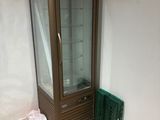 a glass display case in the corner of a room