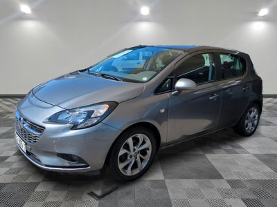 a silver car is parked in a room with a checkered floor