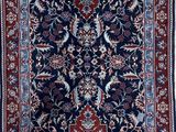 an image of a blue and red rug on a wooden floor