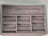 a brown case with a bunch of brushes inside of it