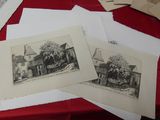 many old photos on a table with a red table cloth