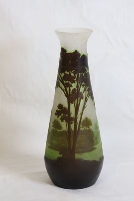 a glass vase with a picture of a tree on it