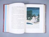 an open book with a picture of a woman sitting on a bench