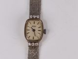 a close up of a watch on a white surface with a white background