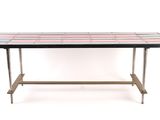 the table is made of metal and has a colorful tile top