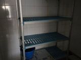 a blue shelf in the corner of a room