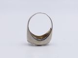 a close up of a silver ring on a white surface