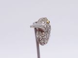 a silver ring with a bird on it sitting on a stick