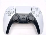 a close up of a video game controller on a white surface
