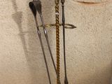 two metal tools that are sitting on a stand