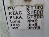 a sign on the side of a white refrigerator that has a lot of stickers on it
