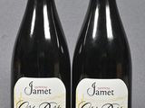 two bottles of wine sitting next to each other on a table
