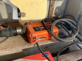 a drill and a box on a wooden table