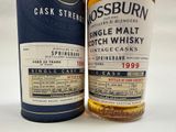 two bottles of whisky sitting next to each other on a white surface