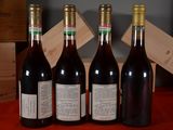 four bottles of wine are lined up on a table