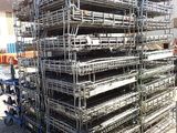 a large pile of metal scaffolding in a parking lot