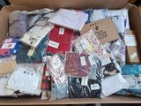 a cardboard box filled with assorted clothing and other items
