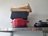 a stack of pots and pans sitting on a shelf