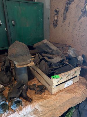 a pile of shoes and other items on a table