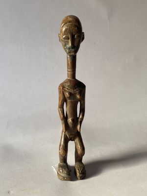 an old bronze figurine of a man holding a baby