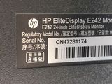 the back of a black laptop with a sticker that says hp elite display e242
