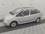 the small silver car is parked in the garage on the checkered floor