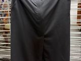 a black shirt hanging on a wire rack in a store