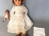 a doll that is sitting next to a cloth diaper