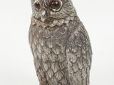 silver owl figurine on a white background