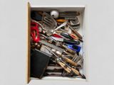 a drawer full of kitchen utensils and knives