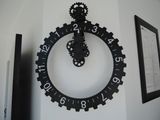 a clock that is on the wall with gears on it