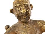 an old bronze statue of a man holding a baby in his arms