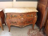 two wooden dressers with marble top tops in a room